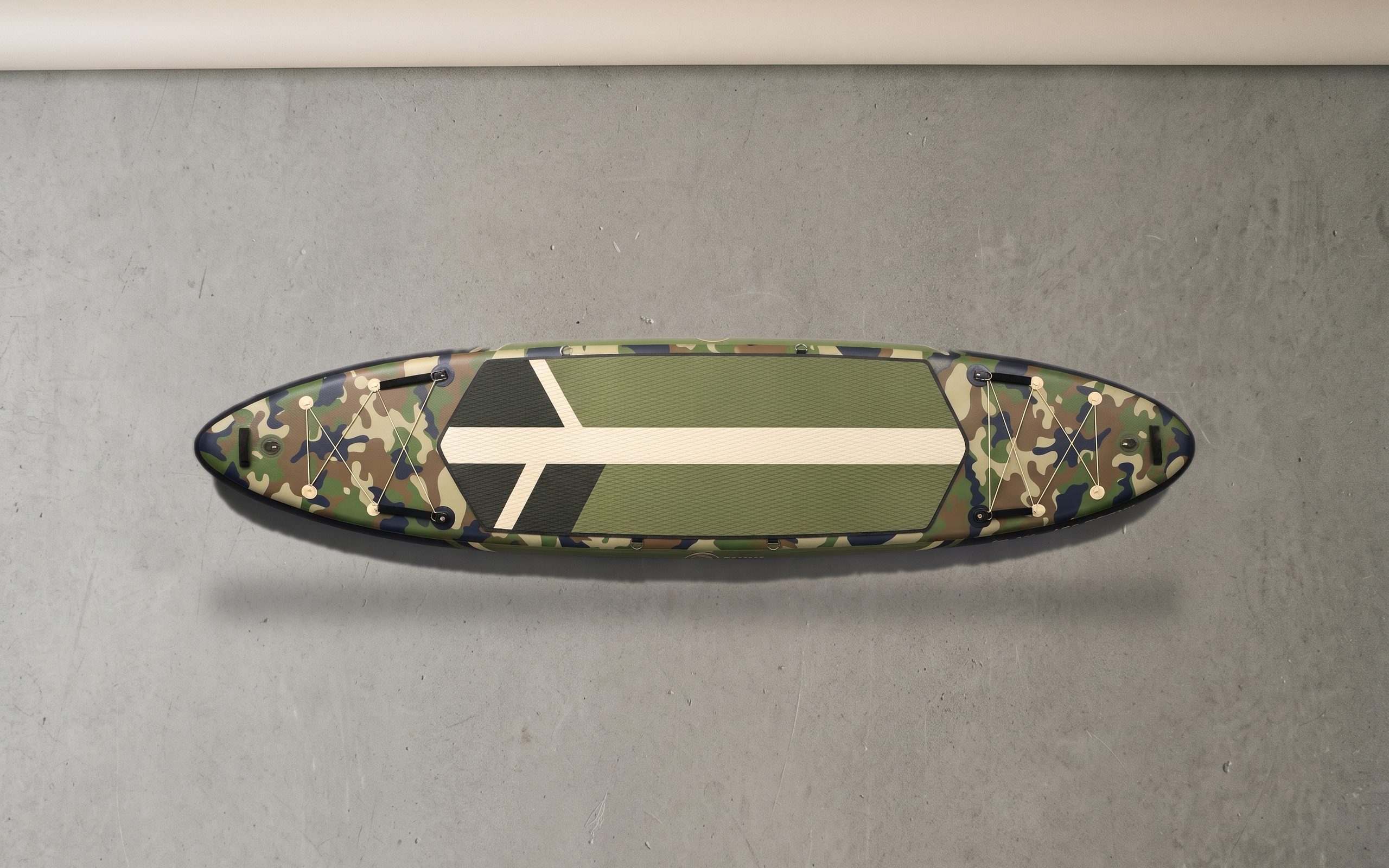 Expedition inflatable paddle board, deck side up on a plain floor.