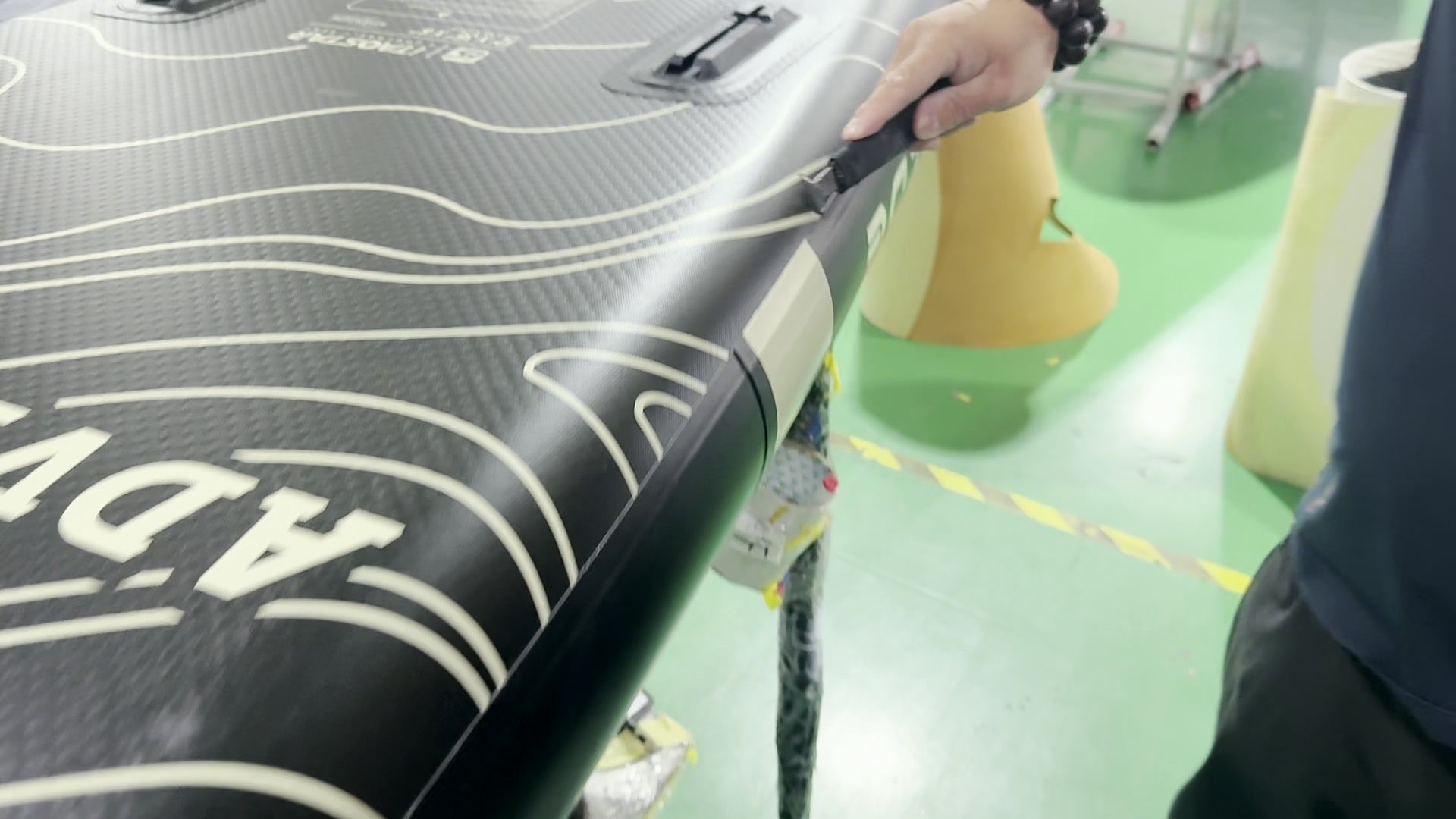 Hand trimming excess seam material with a knife.