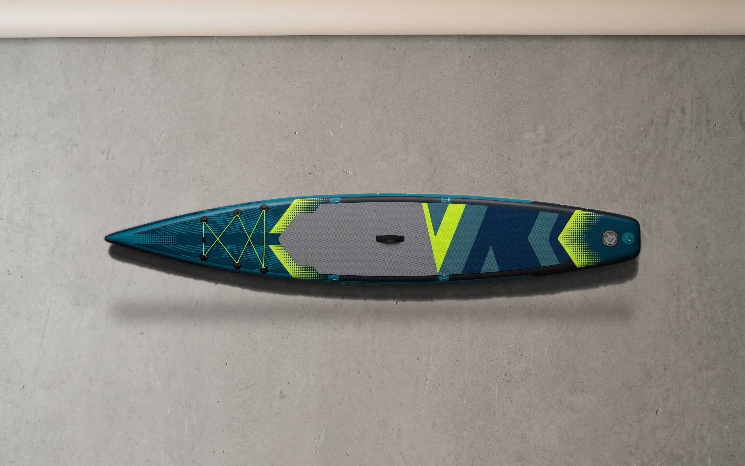 Sport inflatable paddle board, deck side up on a plain floor.